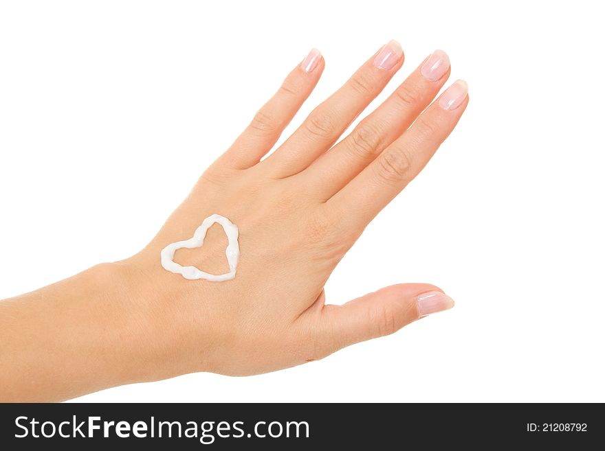 Cream imposed in the form of heart on the female hand on a white background