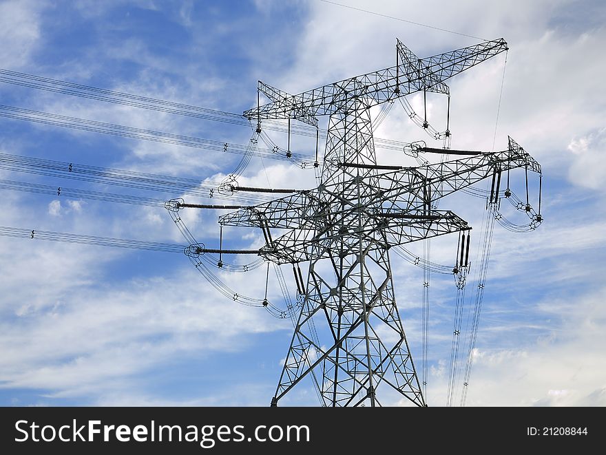 High-tension line and transformer over white cloud.