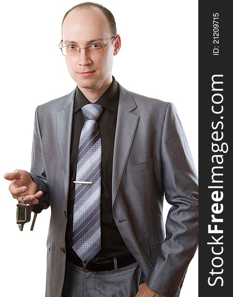 Elegant man with car keys on a white background