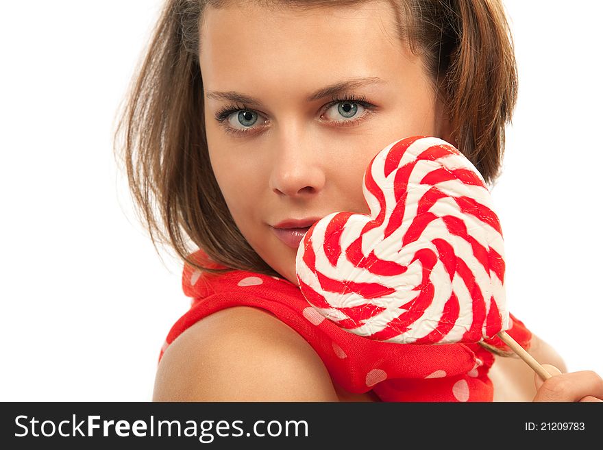 Close-up portrait of young woman with heart shaped lollipop. Close-up portrait of young woman with heart shaped lollipop