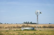 Windmill And Metallic Tank Horizontal Stock Photography