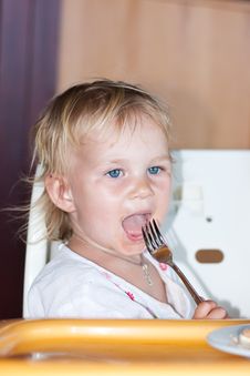 Adorable Baby Eating Cake In A Chair Royalty Free Stock Photos