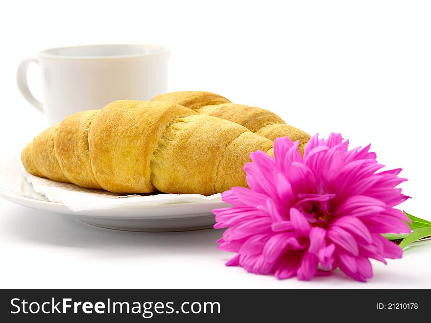 Two croissant and a cup on a saucer. Two croissant and a cup on a saucer