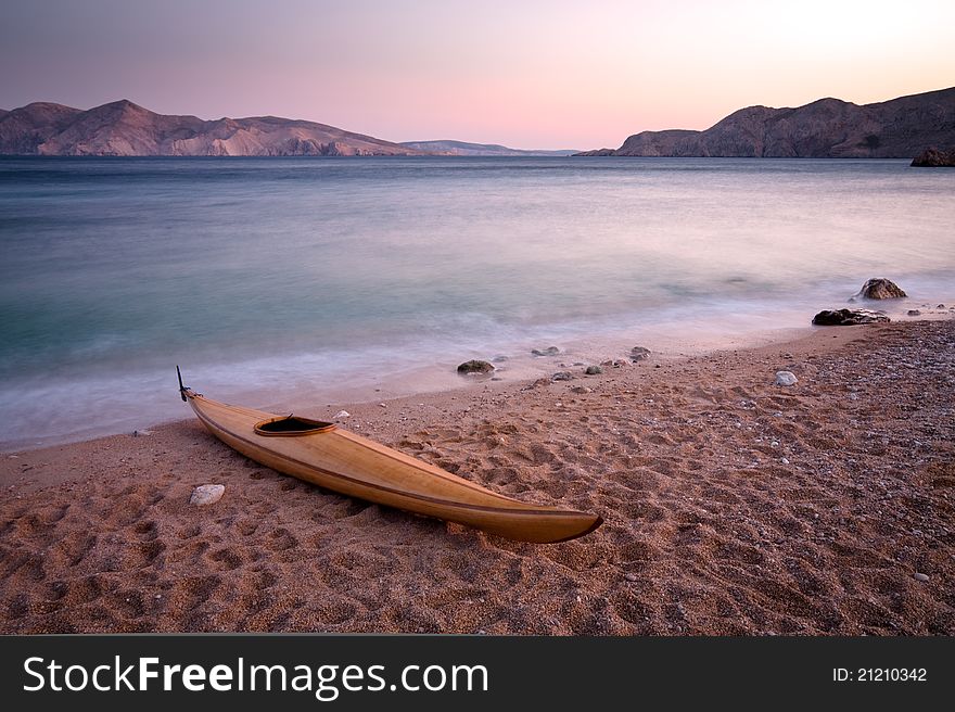 Wooden kayak on pebble beach. (Baska - Krk - Croatia)