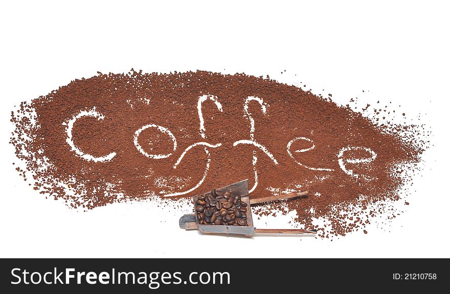 Milled coffee sign with miniature model of the wheelbarrow on a white background