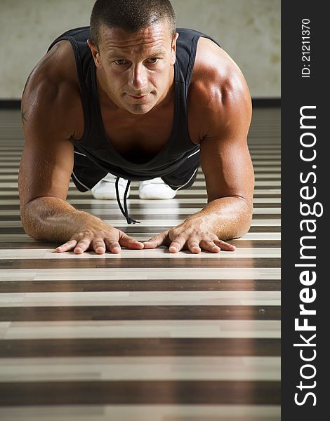 Fitness instructor workingout, doing push ups