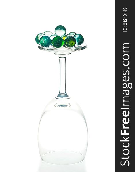 Glass ball and wine glass on white