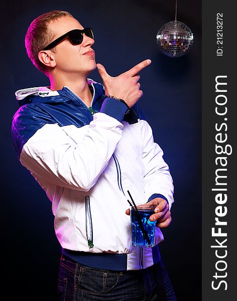 Young stylish guy with a blue cocktail in the nightclub. Young stylish guy with a blue cocktail in the nightclub