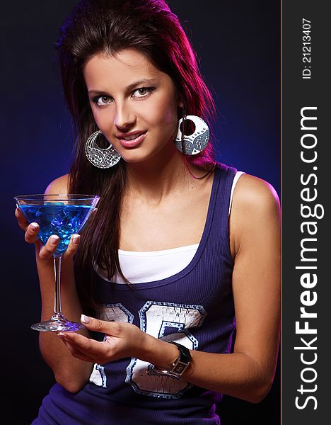 Young and beautiful woman with a blue cocktail in the nightclub. Young and beautiful woman with a blue cocktail in the nightclub