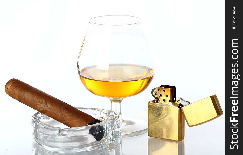 Glass of Whiskey and Cigar against white background