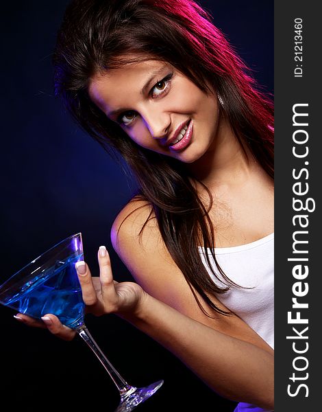 Young and beautiful woman with a blue cocktail in the nightclub. Young and beautiful woman with a blue cocktail in the nightclub