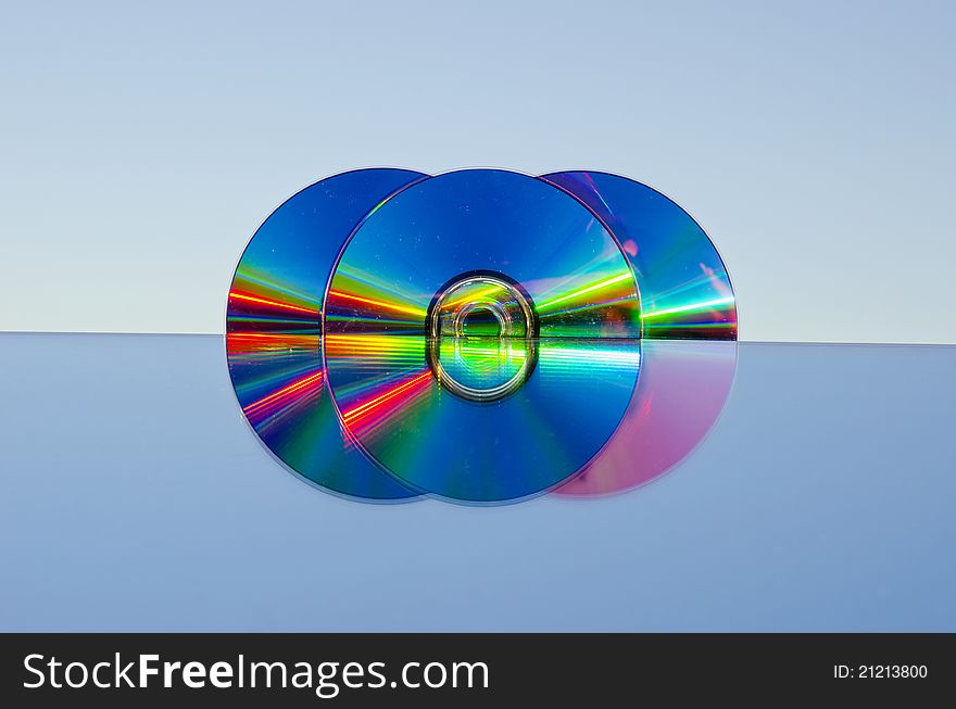 Three dvd discs on mirror and sky