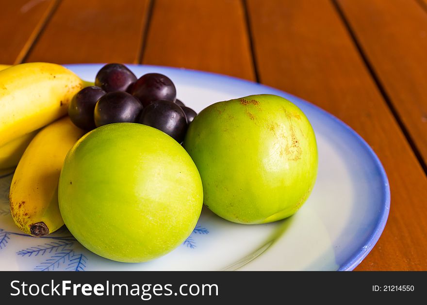 Tropical fruits on the wooden table. Tropical fruits on the wooden table