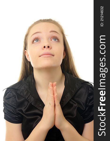 Young girl praying on white surface. Young girl praying on white surface
