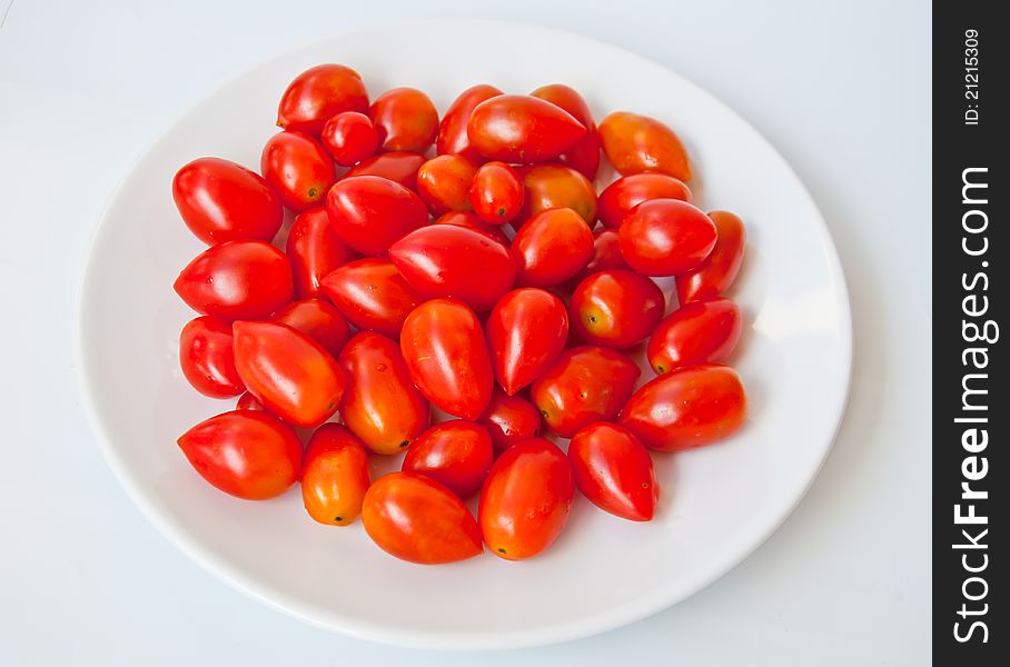 Red tomato call queen tomato in dish on white background