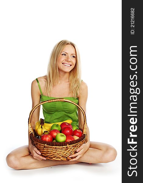 Woman holds a basket of fruit on a white background