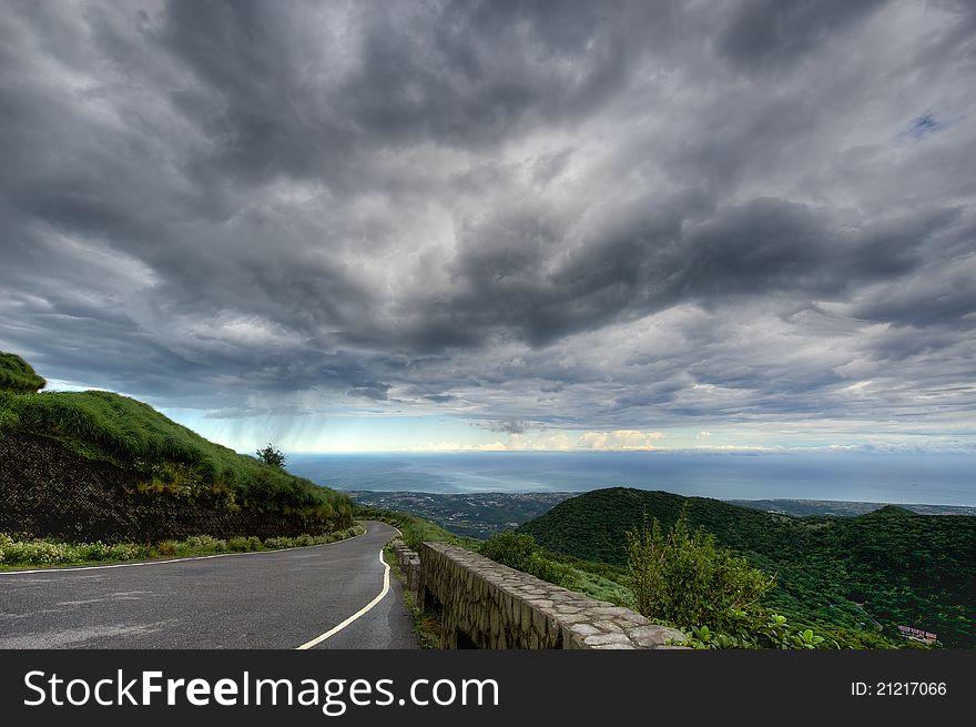 Road in the mountains at sky with clouds