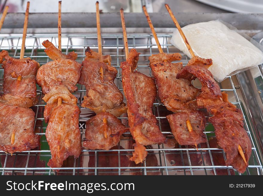 Traditional Thai style grilled pork and sticky rice