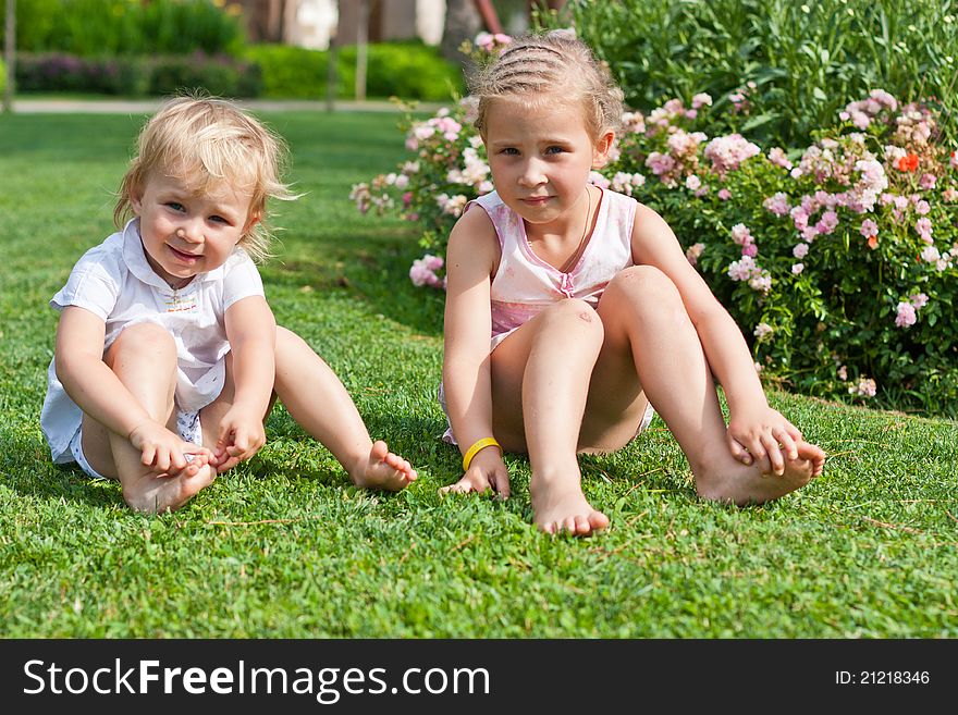 Beautiful girls sitting on the green grass