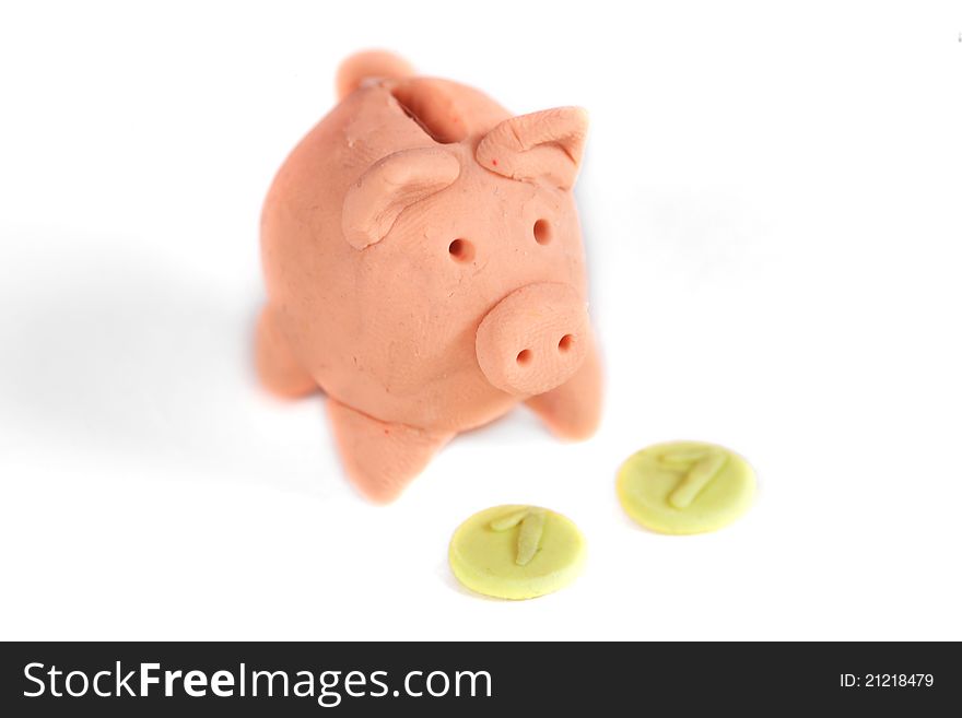 Piggy bank and coin on a white background