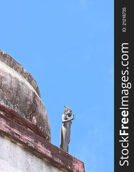 Budha statue standing on old sa-tup with blue sky. Budha statue standing on old sa-tup with blue sky