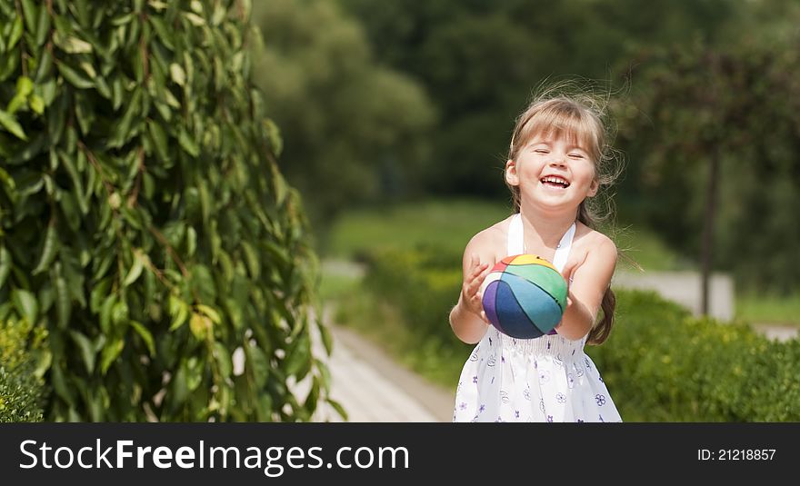 Little Girl Playing Ball In The Park