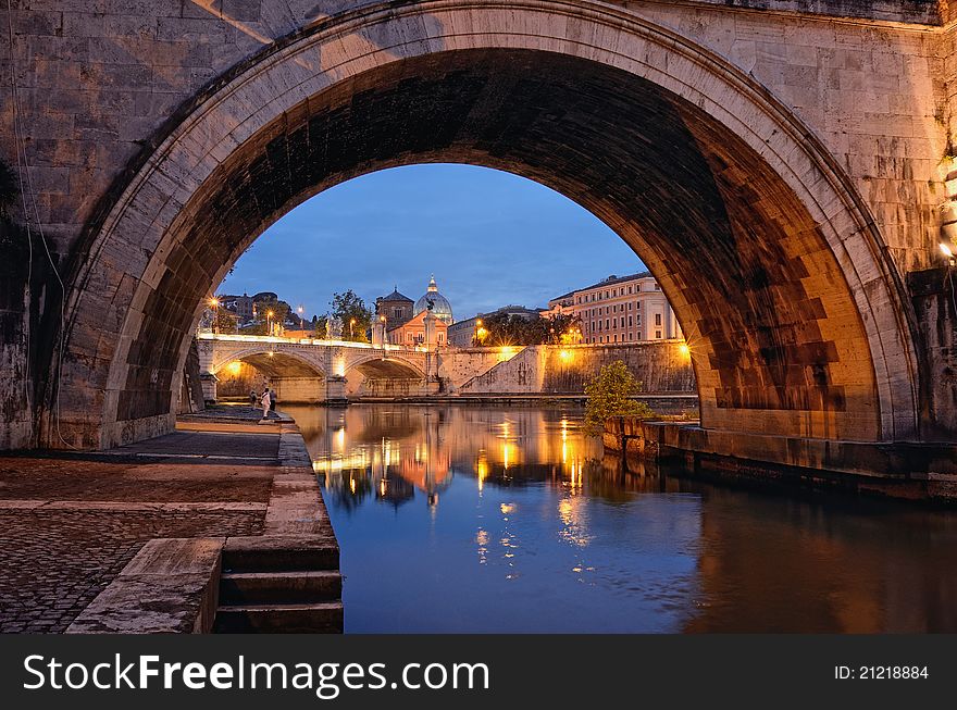 Bridge crossing the river Tiber and Cathedral in twilight. Bridge crossing the river Tiber and Cathedral in twilight