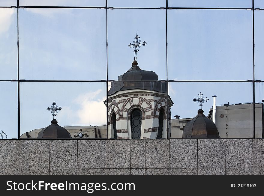Orthodox church reflected in the windows of a modern building. Orthodox church reflected in the windows of a modern building
