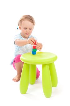 Little Girl Playing With Blocks On The Stool Royalty Free Stock Image Little Girl Playing With Blocks On The Stool Royalty Free Stock Image