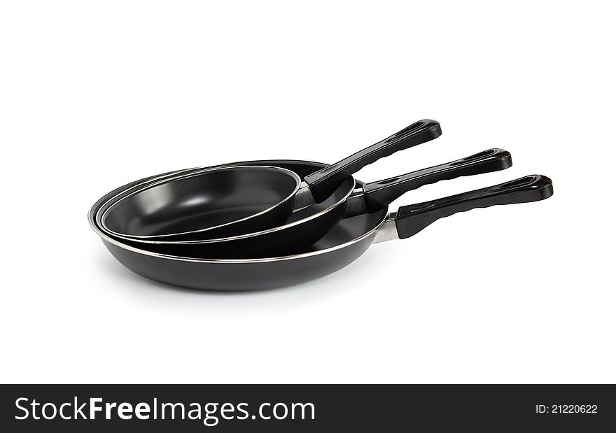 Three new black frying pan on white background. Isolated with clipping path. Three new black frying pan on white background. Isolated with clipping path