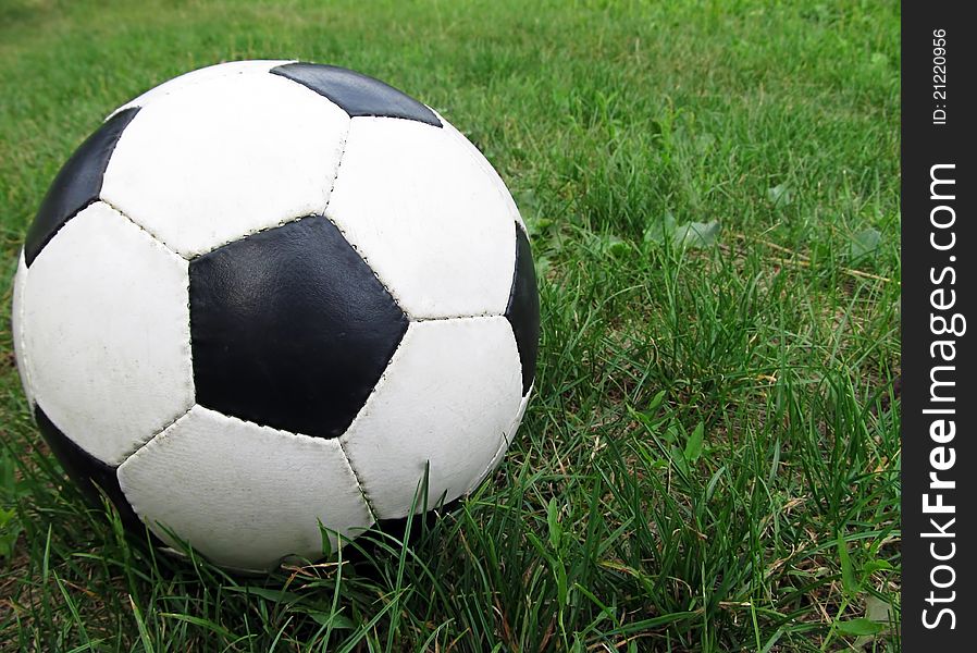 A ball lying on a green grass. A ball lying on a green grass