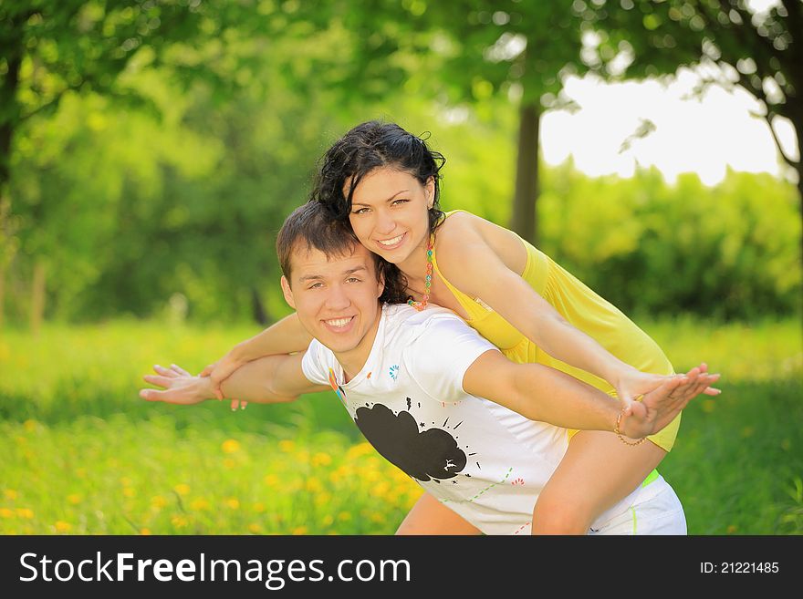 Happy young couple enjoying backriding outdoors