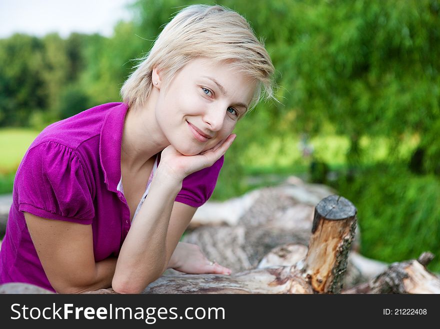 Closeup portrait of young smiling woman outdoors in the park. Closeup portrait of young smiling woman outdoors in the park