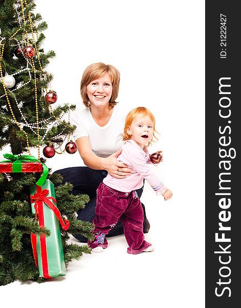 Mother with a son near a new-year tree on a white background