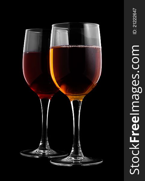 Two glasses of wine on a black background
