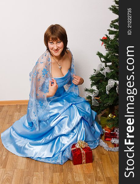 Young woman with gifts near a new-year tree. Young woman with gifts near a new-year tree