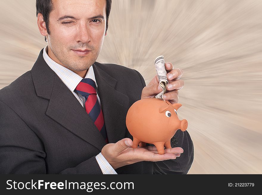 Young businessman holding a piggy bank with dollar bills and blinking his eyel. Young businessman holding a piggy bank with dollar bills and blinking his eyel