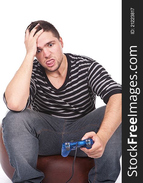 Young and furious man with a joystick for game console