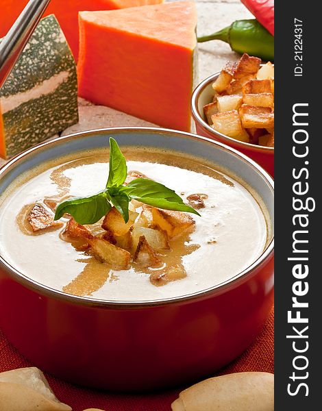 Pumpkin soup with fried potato and croutons