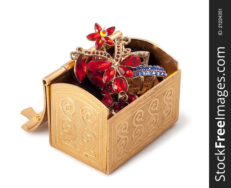 Gold metallic box with jewelry on a white background.