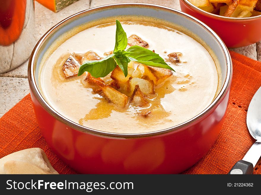 Pumpkin soup with fried potato and croutons