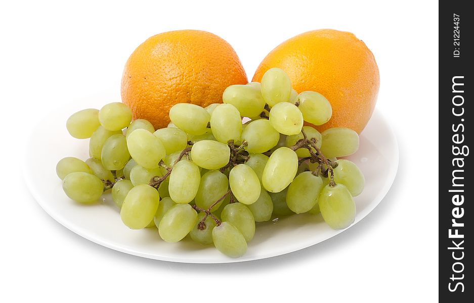 Bunch of grapes and orange on a plate
