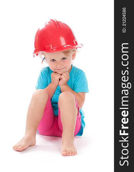 Little girl in the construction red helmet on head