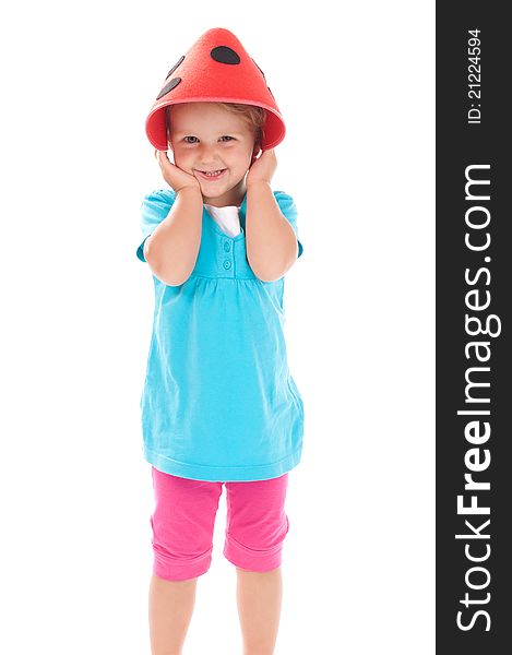 Little girl in studio in funny red hat on her head. Little girl in studio in funny red hat on her head