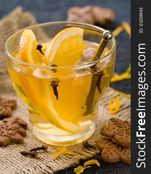 Hot orange drink with ginger cookies. Selective focus. Hot orange drink with ginger cookies. Selective focus