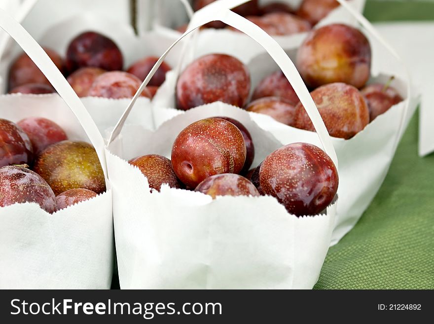 Bags of plums at farmers market