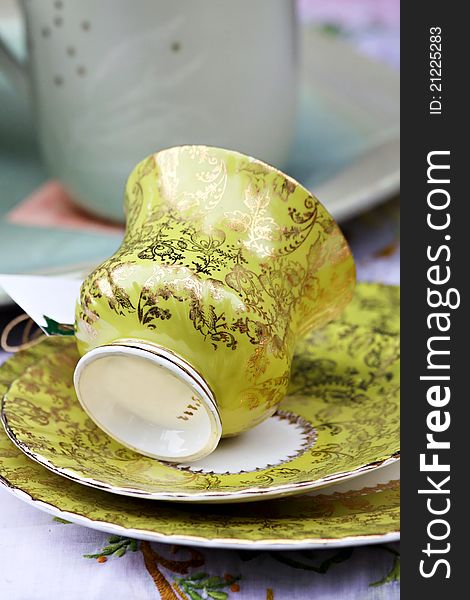 Old green tea cup on a matching saucer