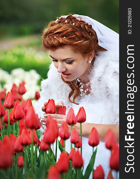 Beautiful bride and red tulips on wedding walk