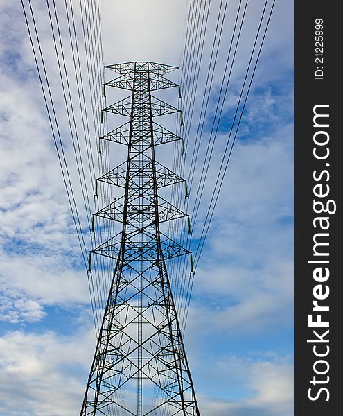 Close-up High voltage tower on blue sky