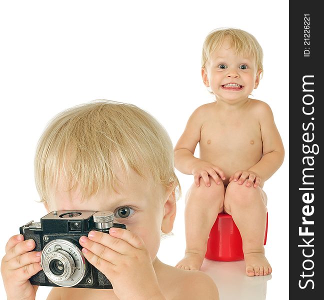 Little boy with old photographic camera and boy on potty on white background. Little boy with old photographic camera and boy on potty on white background